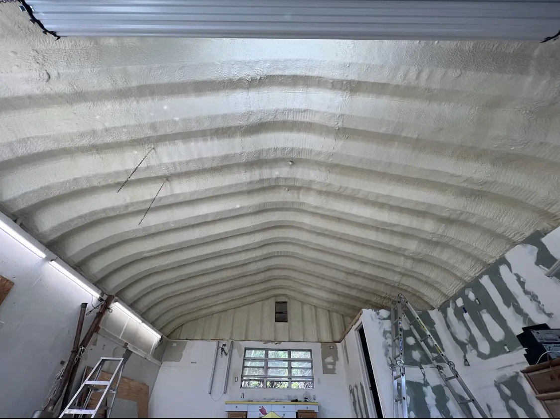 Spray polyurethane foam applied to the underside of a metal roof deck in Stoughton